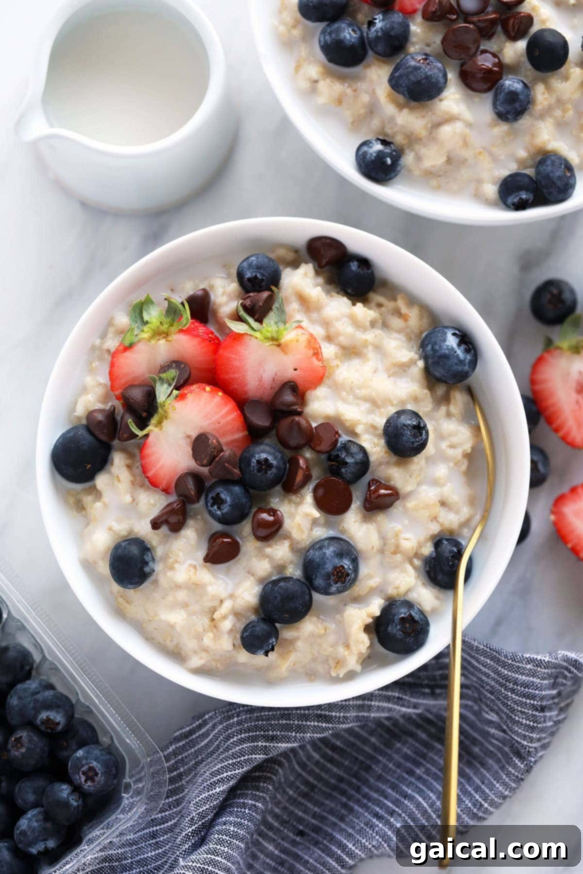 Easy Instant Pot Oatmeal made with old fashioned oats instead of steel cut made in less than half the time! A single bowl of creamy Instant Pot oatmeal, garnished with fresh fruit, ready to be eaten.