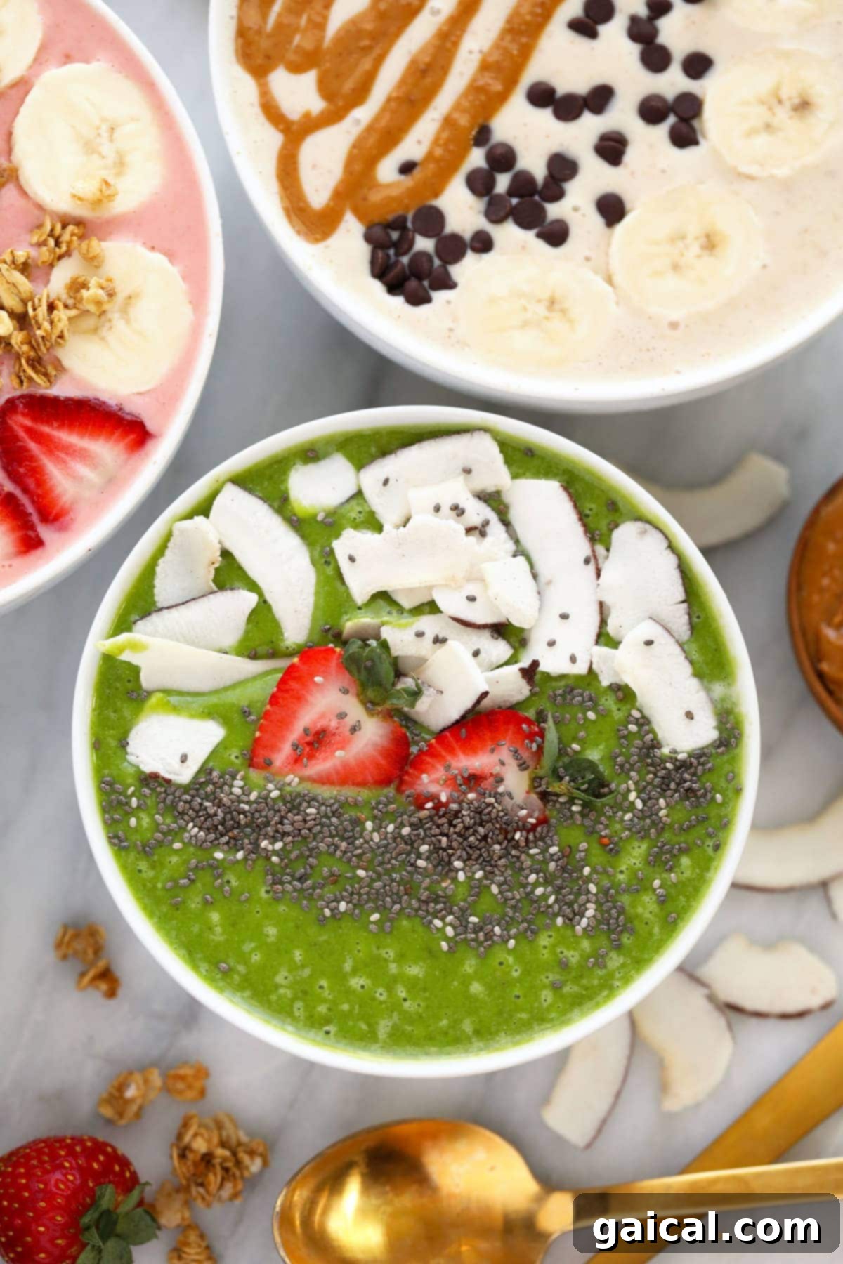 Smoothie Bowl Variations 6 A beautifully presented green smoothie bowl adorned with fresh sliced strawberries, dried coconut flakes, and a sprinkle of chia seeds.