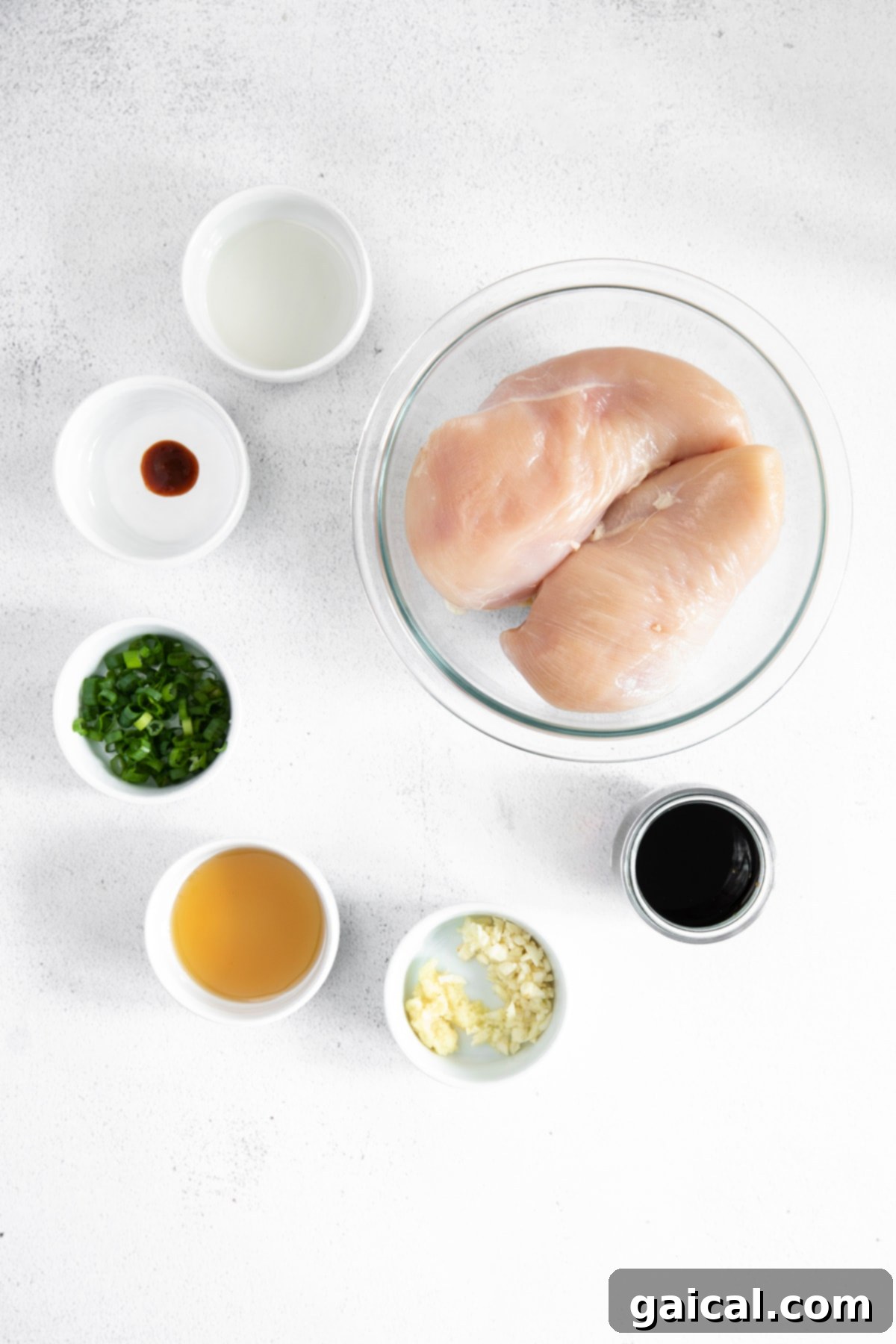 Seriously delicious baked teriyaki chicken breast comes together with easy-to-find ingredients. This teriyaki chicken comes out so tender and saucy! All the fresh ingredients for homemade teriyaki chicken marinade displayed neatly on a kitchen countertop.