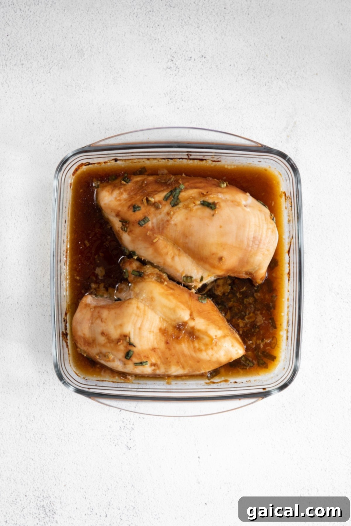 When in doubt, make this easy Baked Teriyaki Chicken Breast. The chicken is marinated in an easy homemade teriyaki chicken marinade and then baked in a casserole dish until tender. Perfectly cooked teriyaki chicken breast in a casserole dish, glistening with sauce.