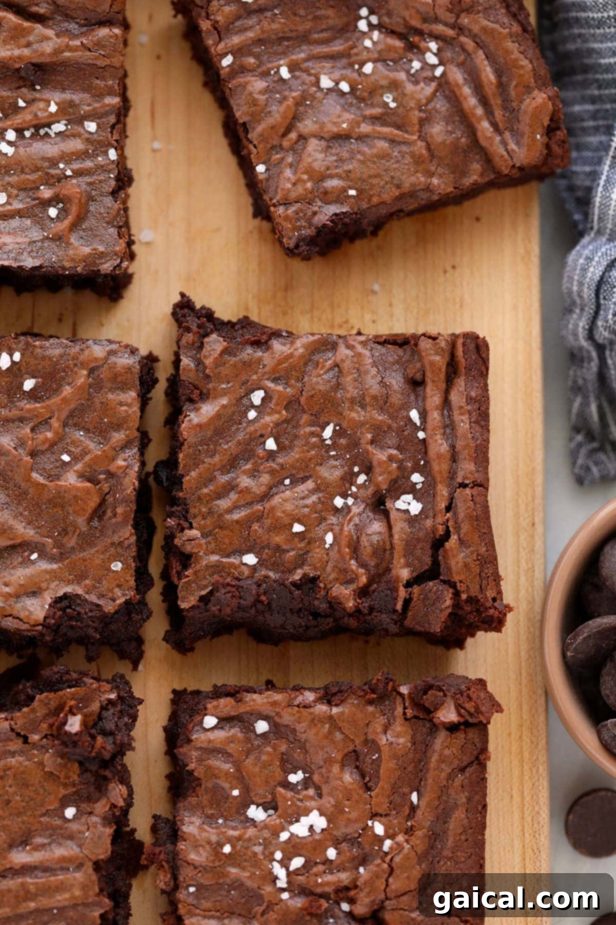 Fudgy brownies freshly baked on a rustic cutting board, ready to be sliced