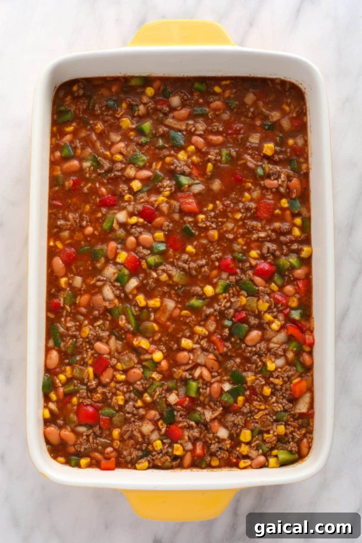 All the delicious ingredients for this Mexican casserole mixed together in a casserole dish, ready for baking.