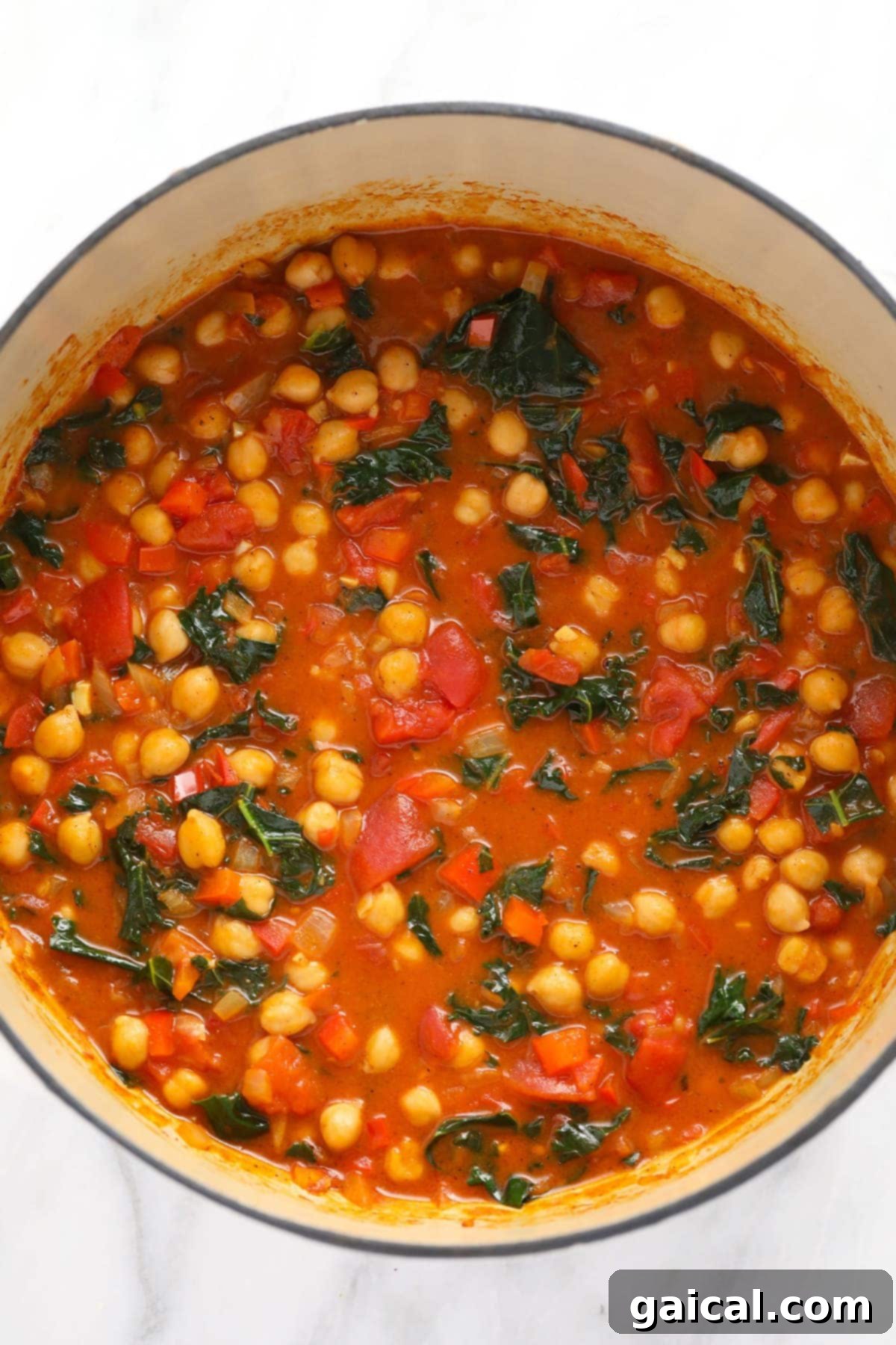 Ready-to-Serve Chickpea Curry The finished chickpea curry, vibrant and steaming, in a Dutch oven, ready to be served.