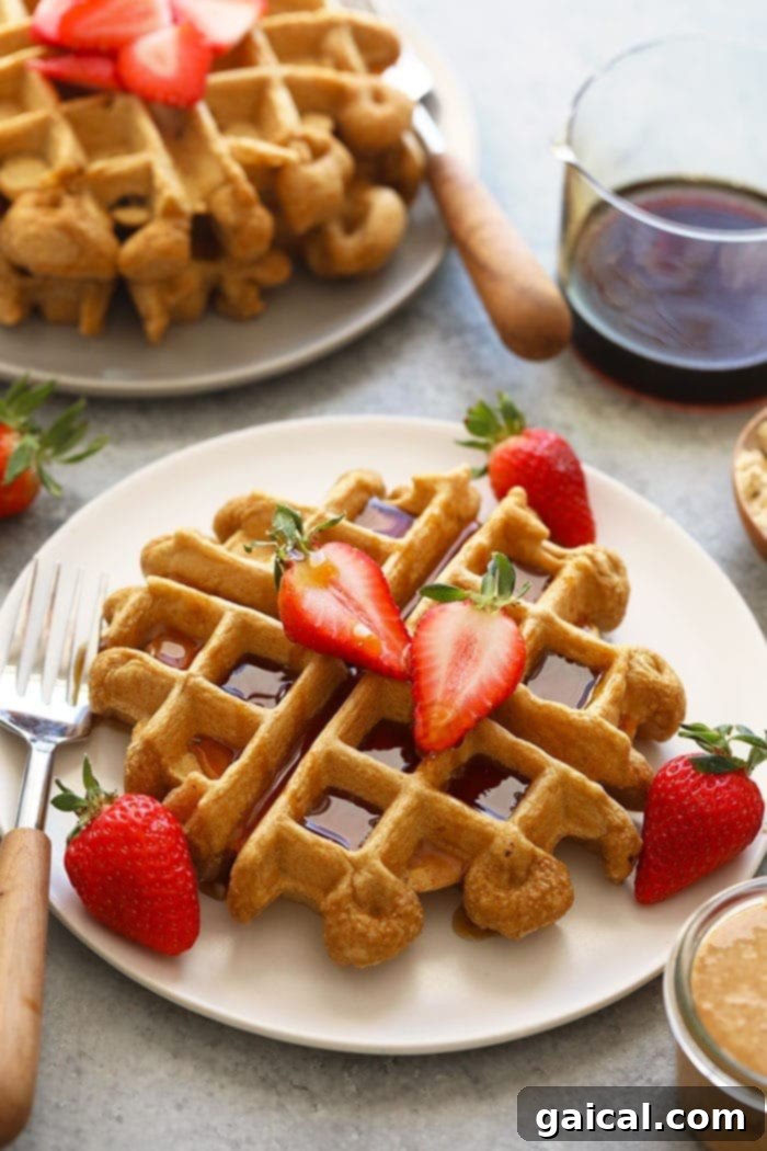 Protein Waffles with Delicious Toppings Healthy protein waffles adorned with fresh berries and maple syrup