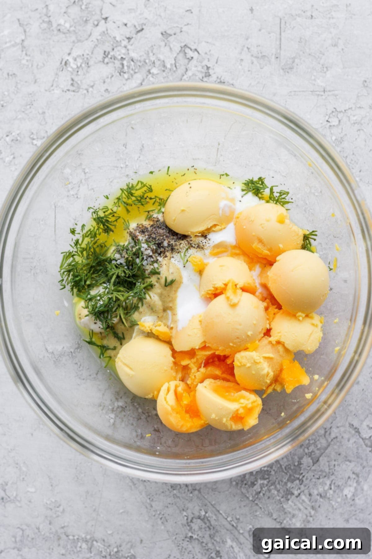 Smooth and creamy deviled egg filling, perfectly blended. The creamy and well-combined deviled egg filling, mixed in a bowl with a spoon, ready to be piped into egg whites.