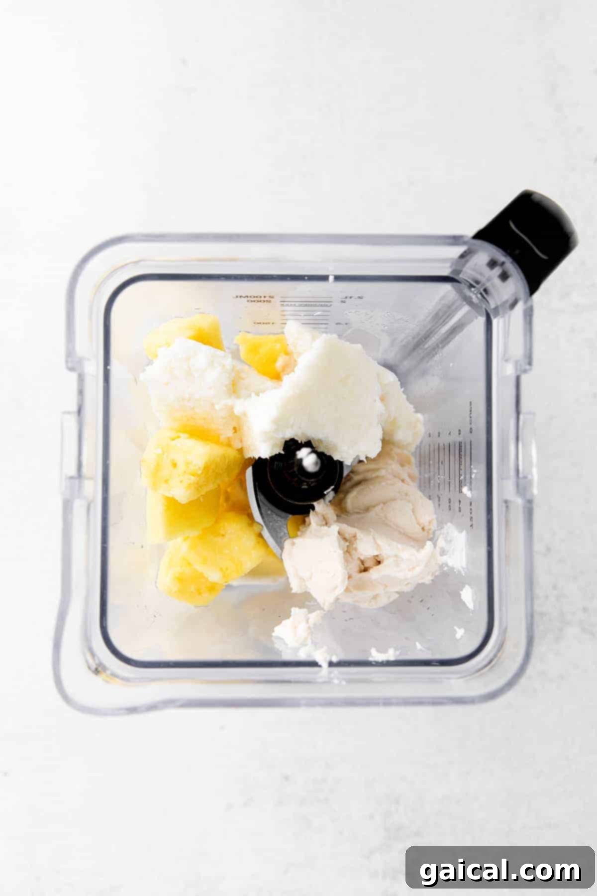 Piña Colada ingredients being blended in a high-speed blender, creating a smooth, creamy texture.