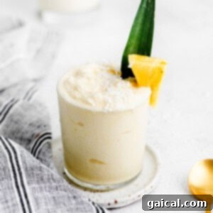 Pina Colada in a glass with a pineapple wedge