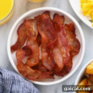 Crispy bacon strips on a plate, ready to be served.