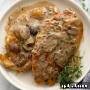Chicken breasts with mushroom sauce, inspired by the classic Chicken Marsala, served on a white plate.