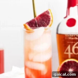 A vibrant blood orange smash cocktail, ready to drink.