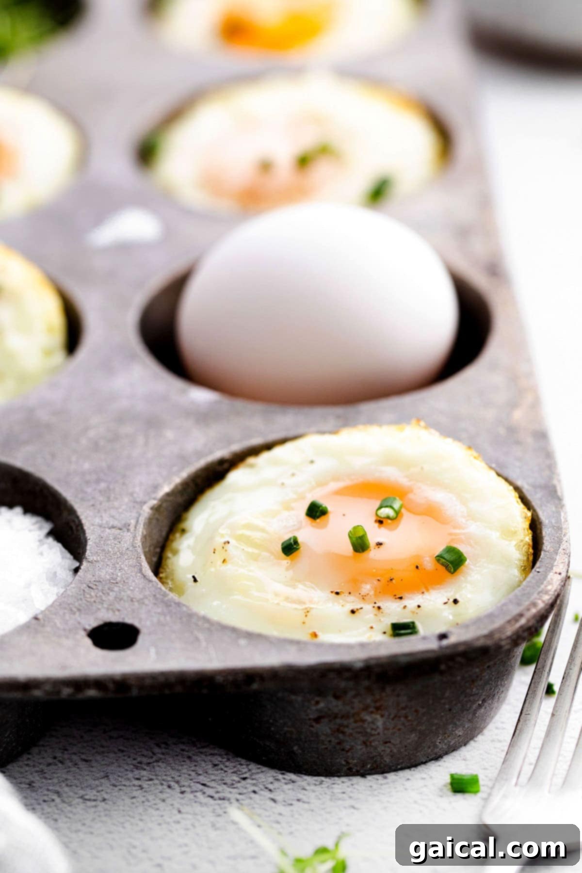 How to bake eggs in the oven for a simple, protein-rich meal. baked eggs in muffin tin with fresh herbs