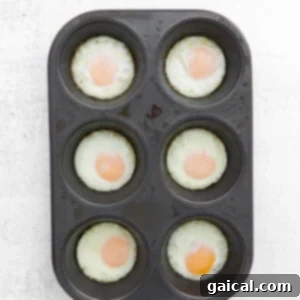 How to bake fried eggs in an oven using a muffin tin, showing cooked eggs.
