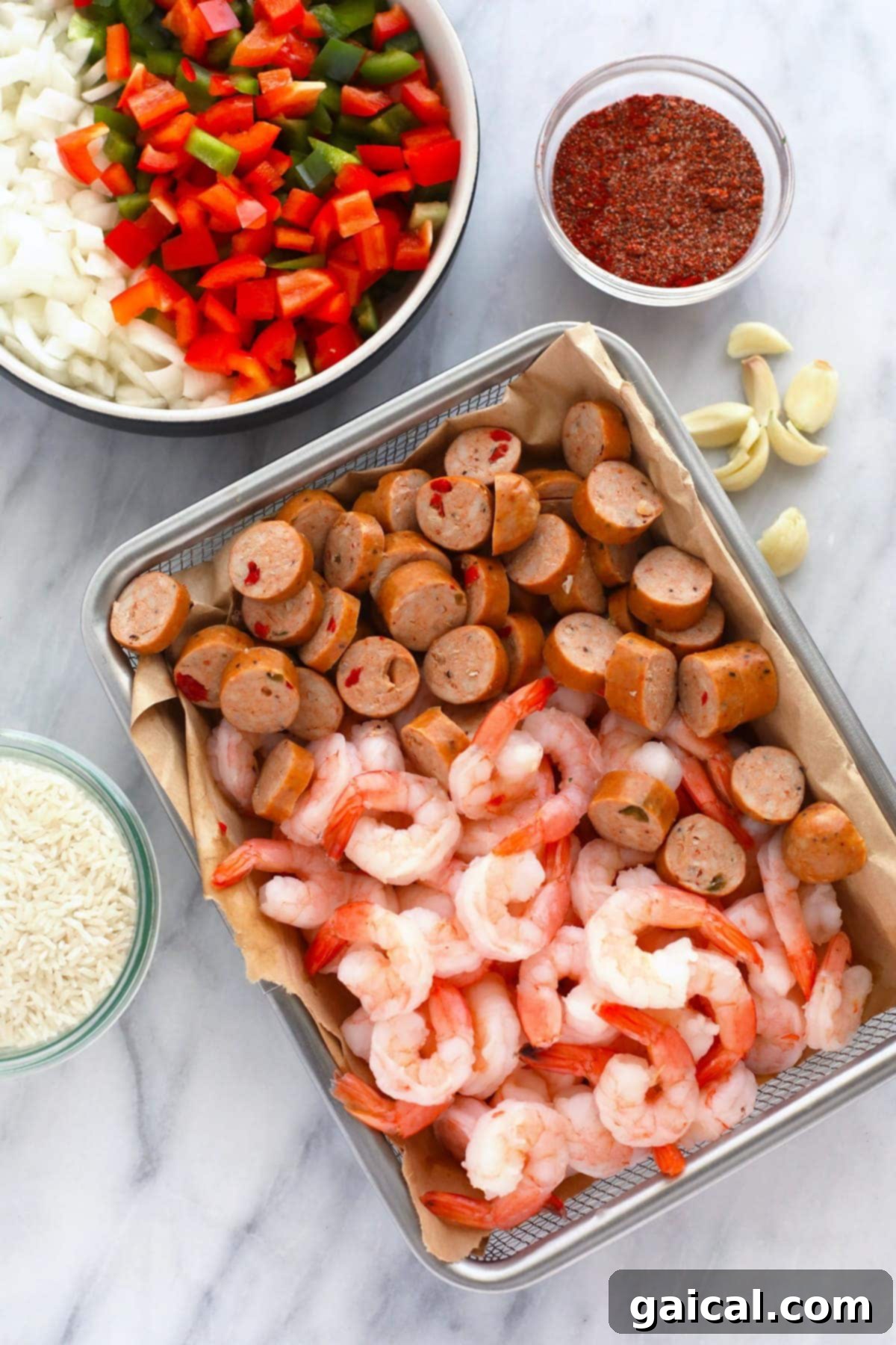 Easy Instant Pot Jambalaya 3 Bowls filled with fresh, colorful ingredients like raw shrimp, sliced andouille sausage, diced bell peppers, minced onions, and garlic, arranged on a countertop, ready to be added to an Instant Pot.
