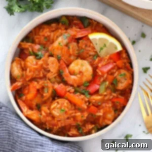 Easy Instant Pot Jambalaya 9 Jambalaya in a bowl, garnished with fresh herbs, for a delicious and easy dinner.