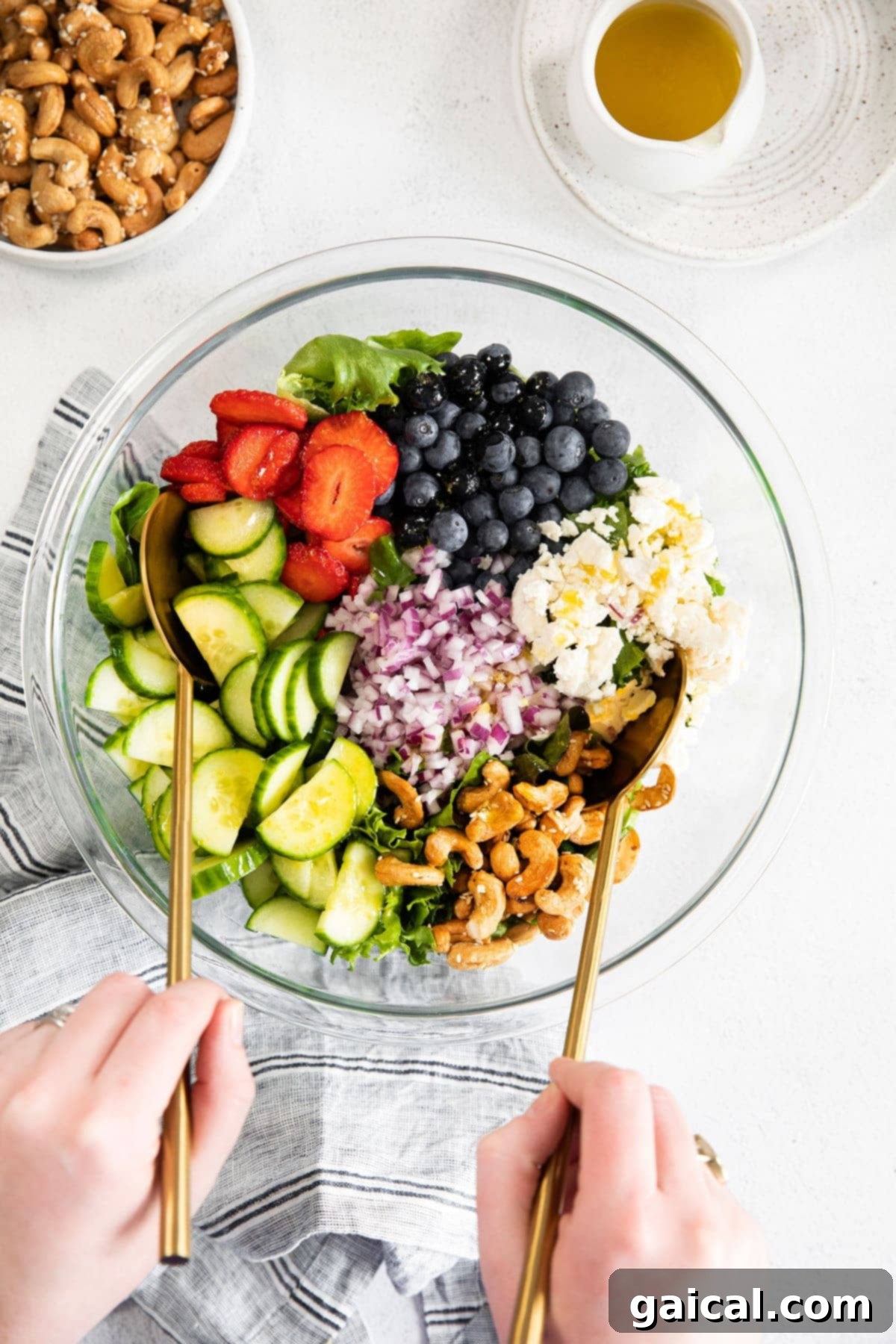Vibrant Spring Greens 2 Spring mix salad ingredients in a bowl, showcasing fresh produce, nuts, and cheese.
