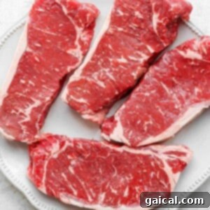 raw steak on plate.