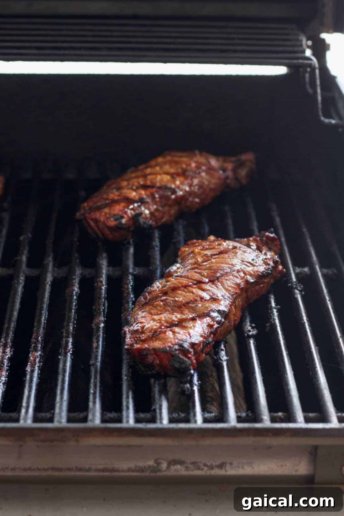 Grilling steaks on a gas grill, showing beautiful sear marks.