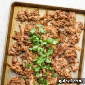 Crispy carnitas on a baking sheet, ready for serving.