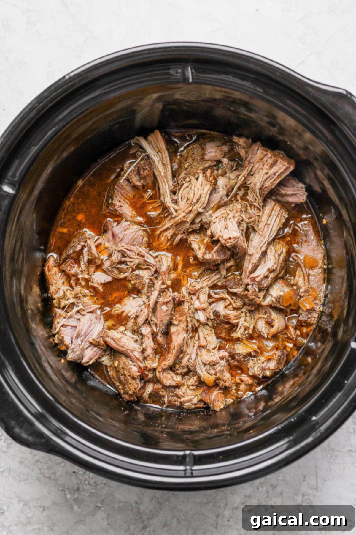 Perfect Homemade Carnitas 6 Shredded, tender carnitas mixed with juices in a slow cooker, before crisping.