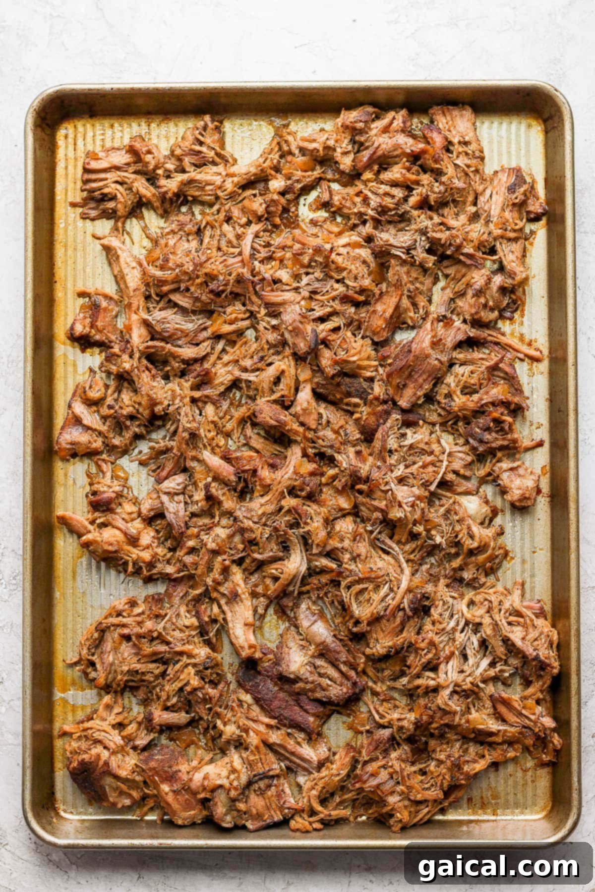Perfect Homemade Carnitas 8 Close-up of crispy carnitas on a baking sheet after broiling.