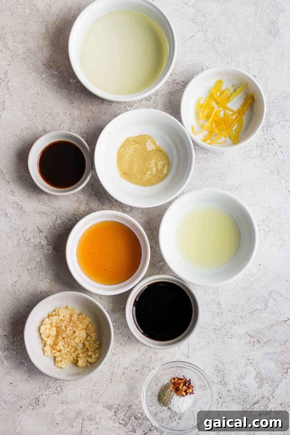 Fresh and Zesty: All the Key Ingredients for the Best Grilled Chicken Marinade Recipe. A vibrant selection of fresh ingredients for the grilled chicken marinade, including lemons, garlic, balsamic vinegar, olive oil, and honey, neatly arranged on a kitchen counter.