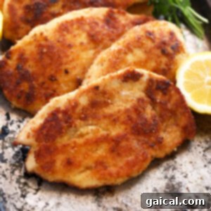 A beautifully crusted chicken breast, golden and crispy.