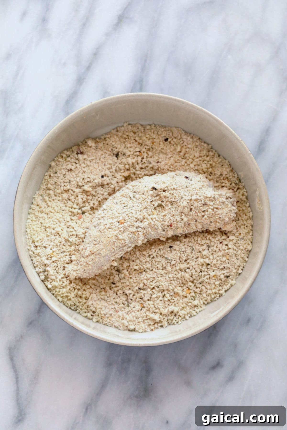 The most crispy on the outside and tender on the inside Air Fryer Chicken Tenders! These chicken tenders (air fryer style) are so easy to make, high protein, and kid-friendly. dredging chicken in breadcrumbs