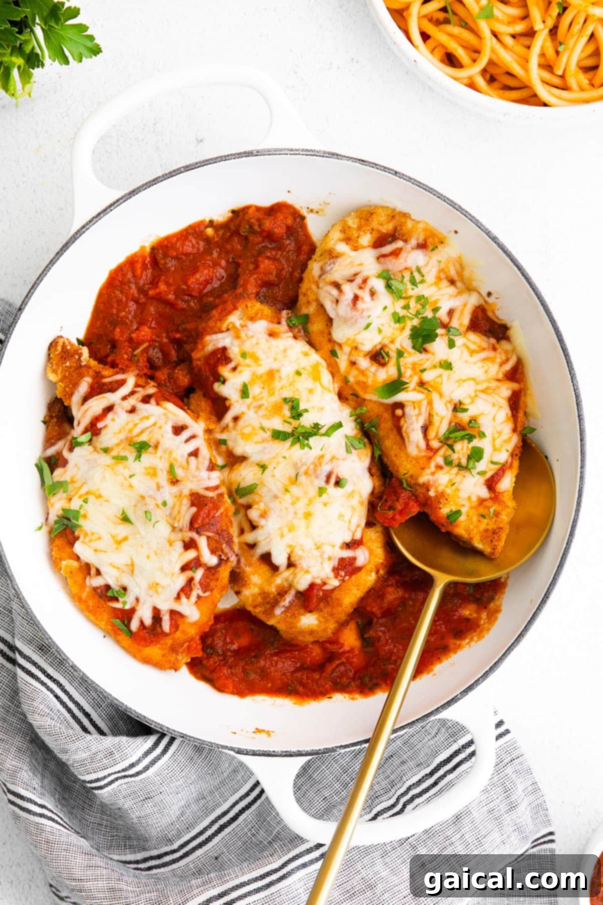 Crispy chicken cutlet with marinara sauce and melted cheese on top, ready to be served.