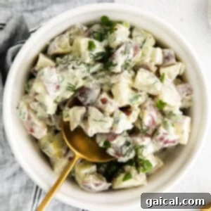 A bowl of red potato salad, ready to serve.