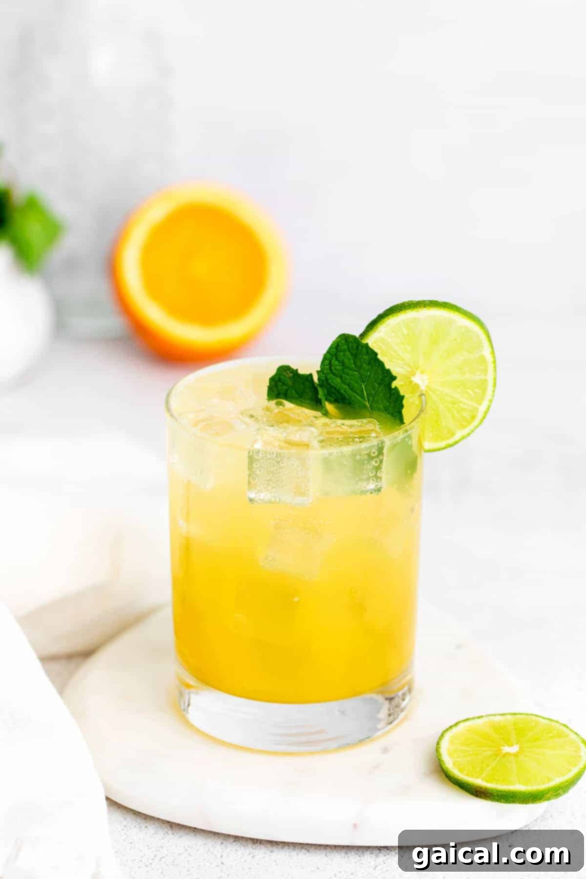 A beautifully garnished virgin margarita, ready to be enjoyed. A refreshing virgin margarita garnished with fresh mint and a lime wedge.