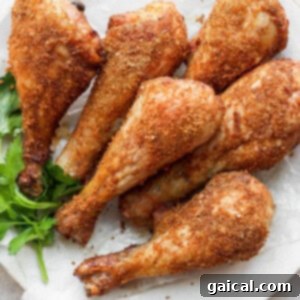 Crispy smoked chicken legs ready to be served on a plate.