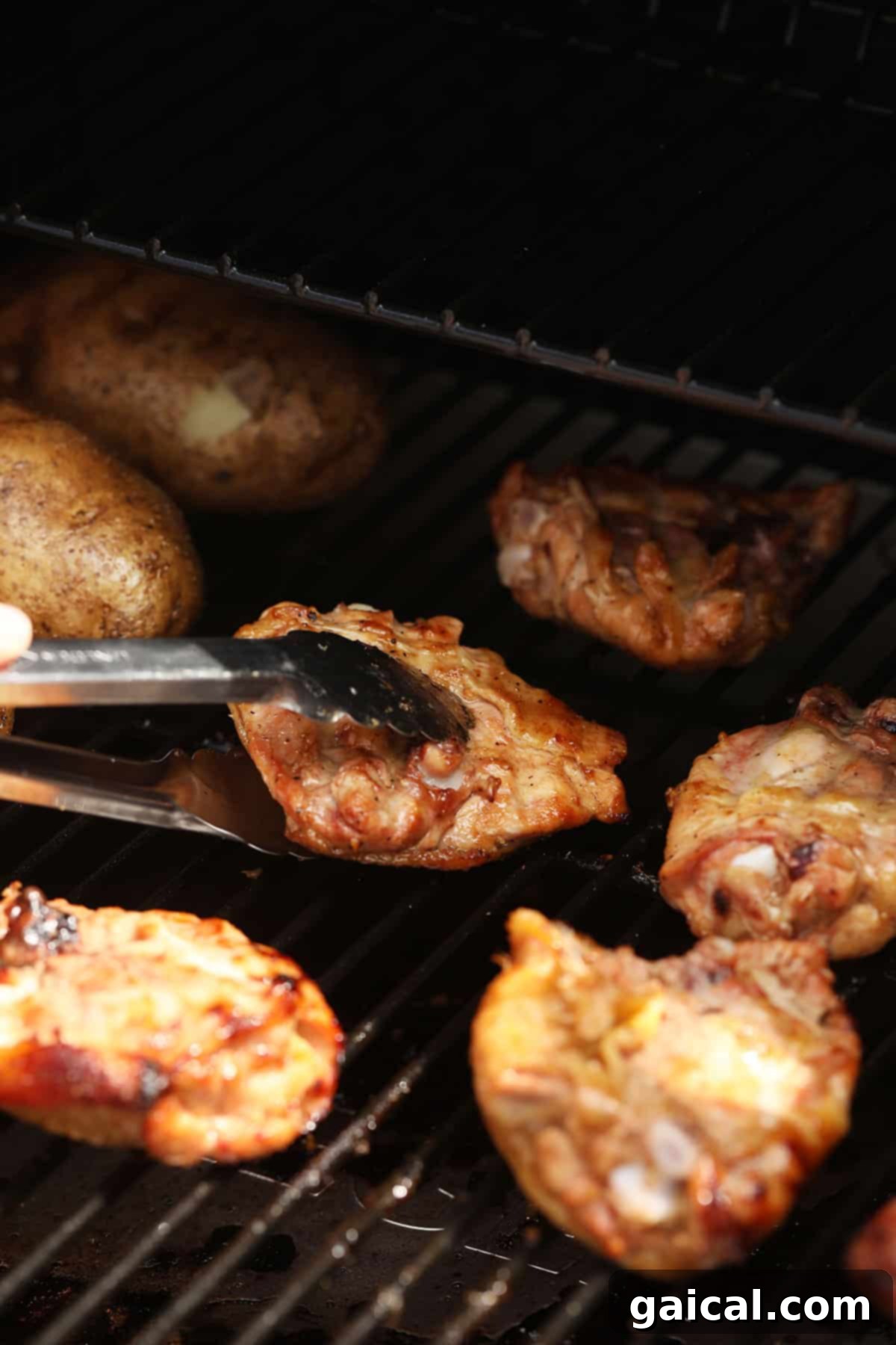 Perfectly Smoked Chicken Thighs 7 Flipping chicken thighs on a smoker for even cooking.