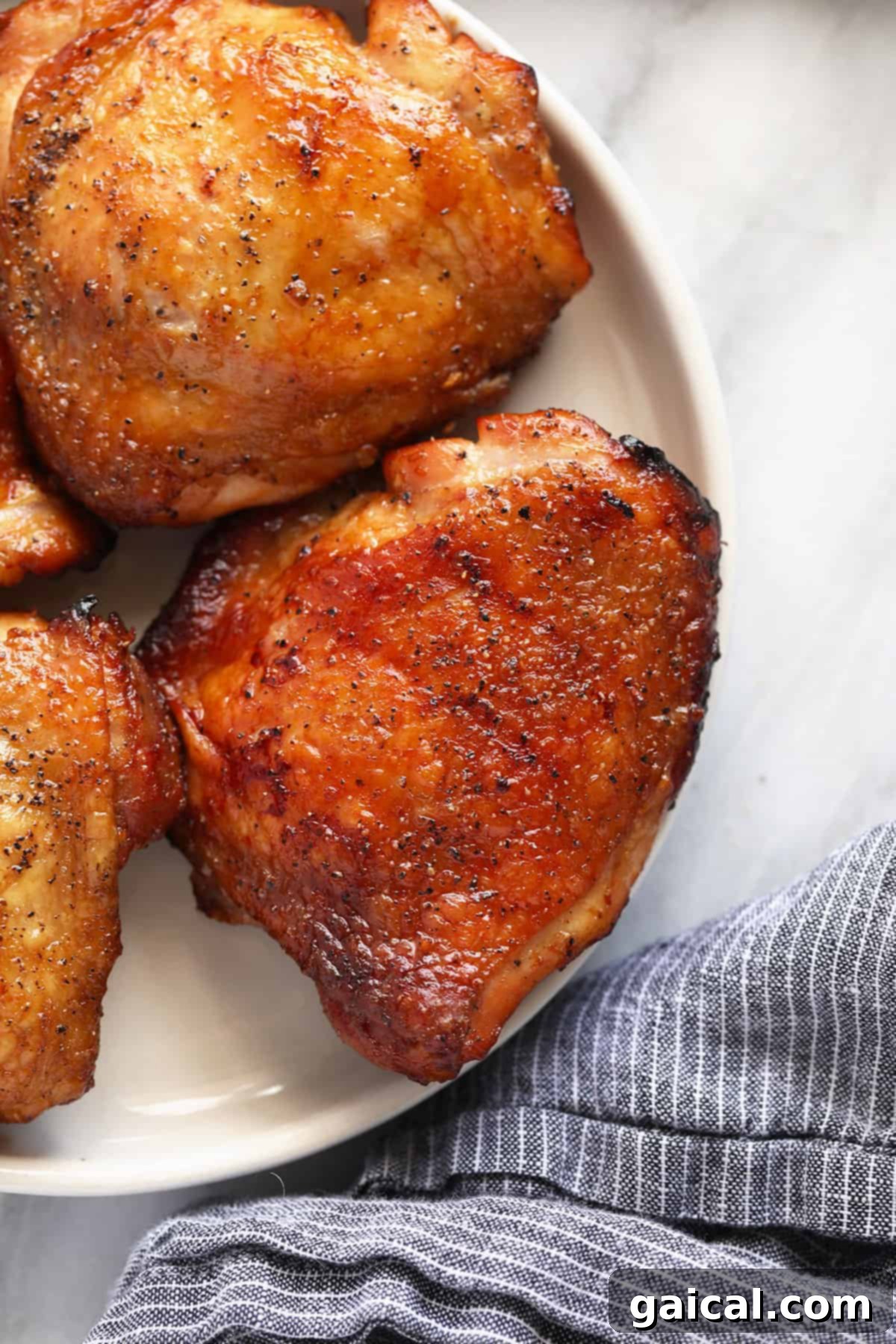 Perfectly Smoked Chicken Thighs 8 Plated smoked chicken thighs with crispy skin and juicy meat.