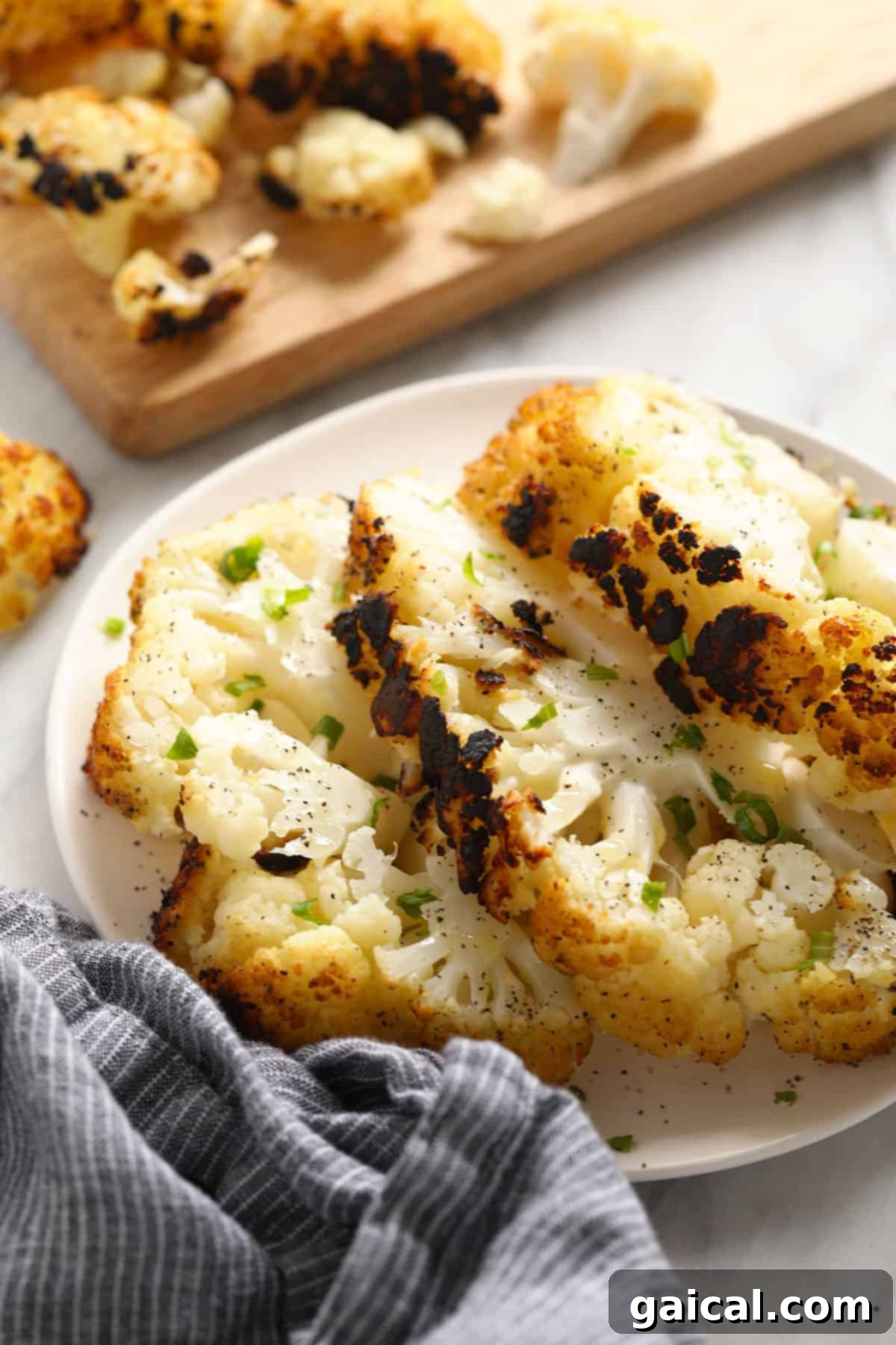 Fire-Kissed Cauliflower 2 A plate of perfectly grilled cauliflower steaks, showcasing a tender interior and crisp, charred edges.