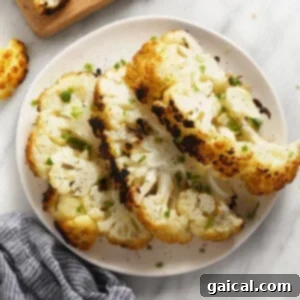 a white plate topped with cauliflower next to a cutting board.