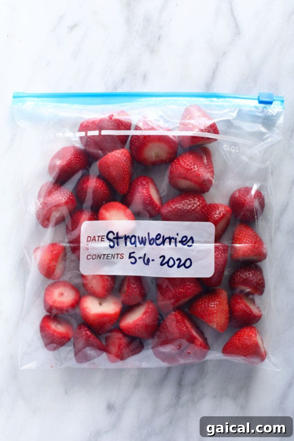 A transparent freezer bag filled with perfectly frozen strawberries, ready for use in various recipes.