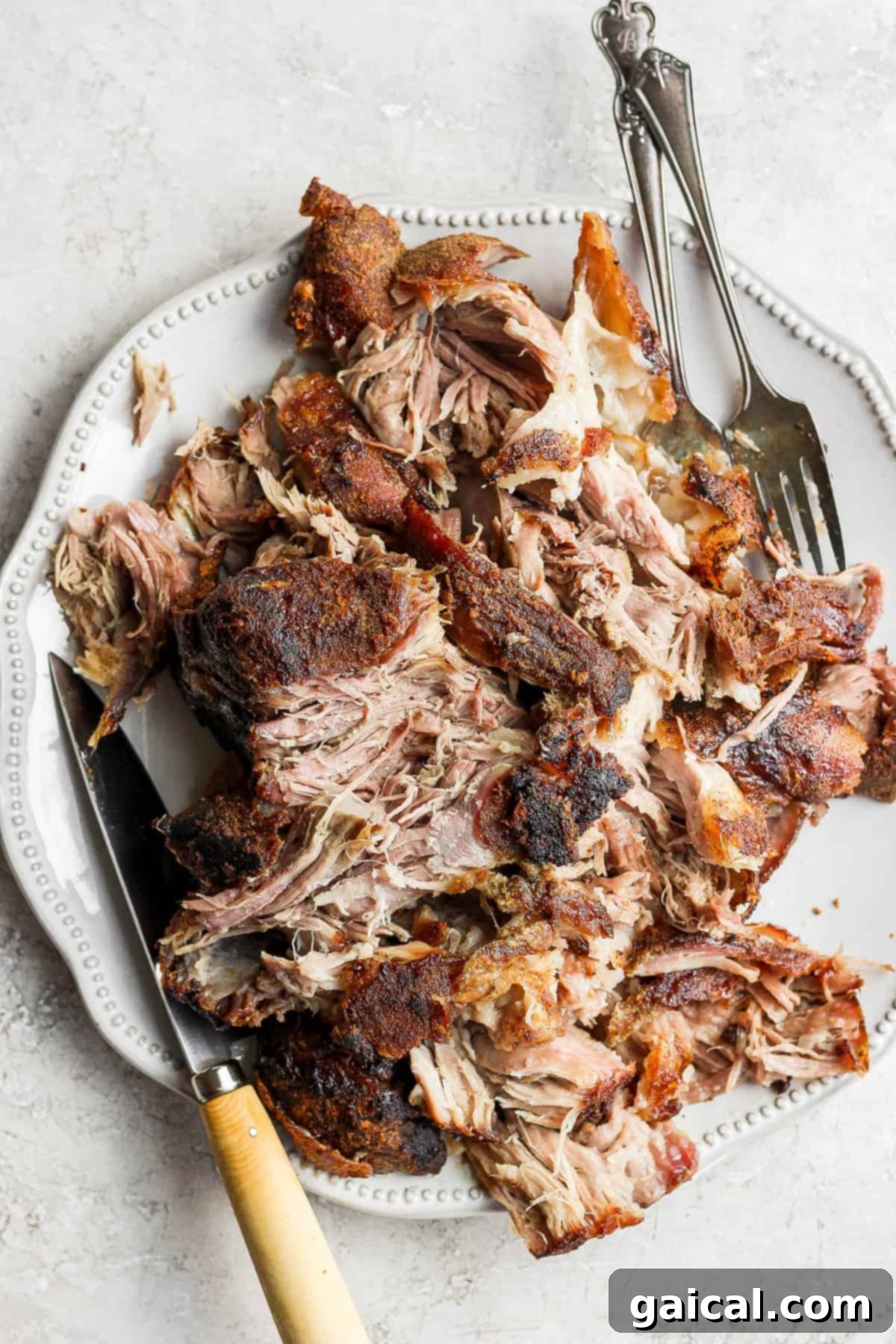 A vibrant platter of shredded slow roasted pork shoulder, beautifully garnished and ready for a festive feast.