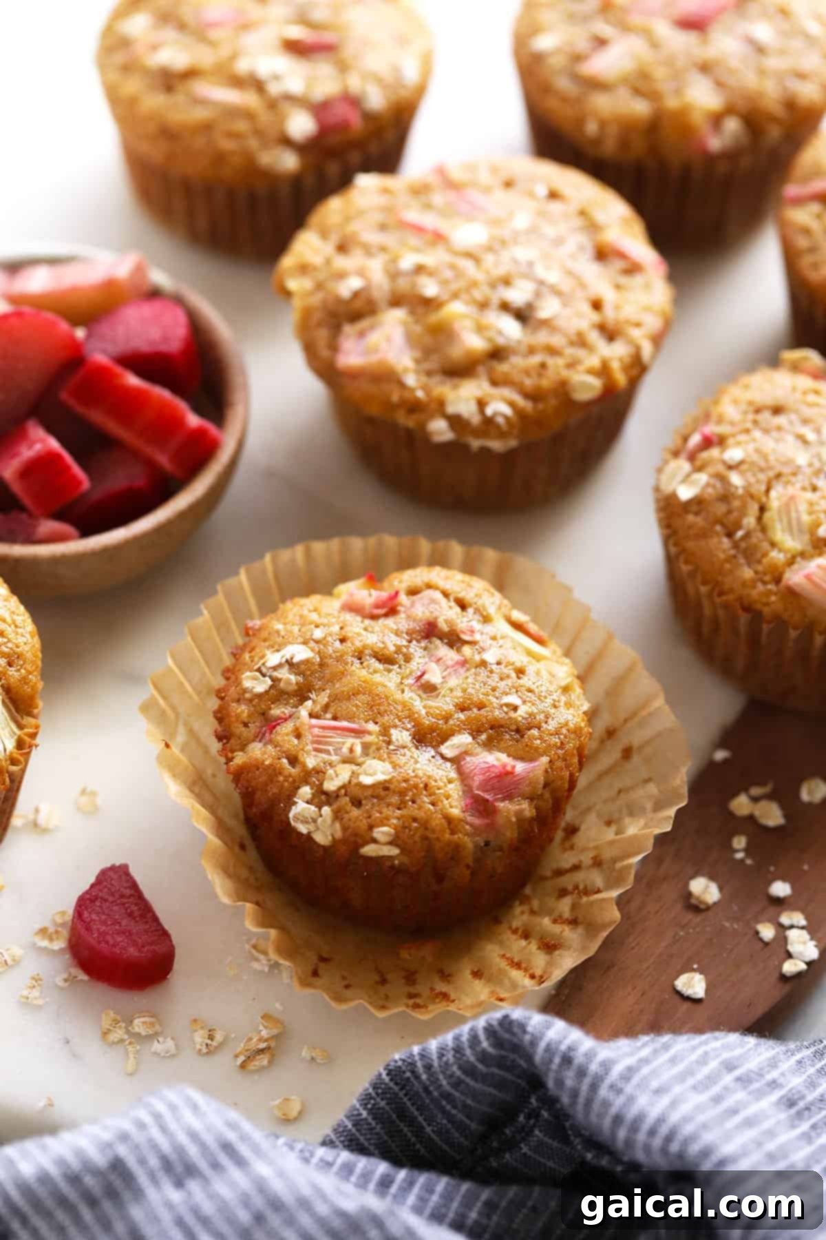Sweet and Tangy Rhubarb Muffins 2 Rhubarb muffins on a counter top.