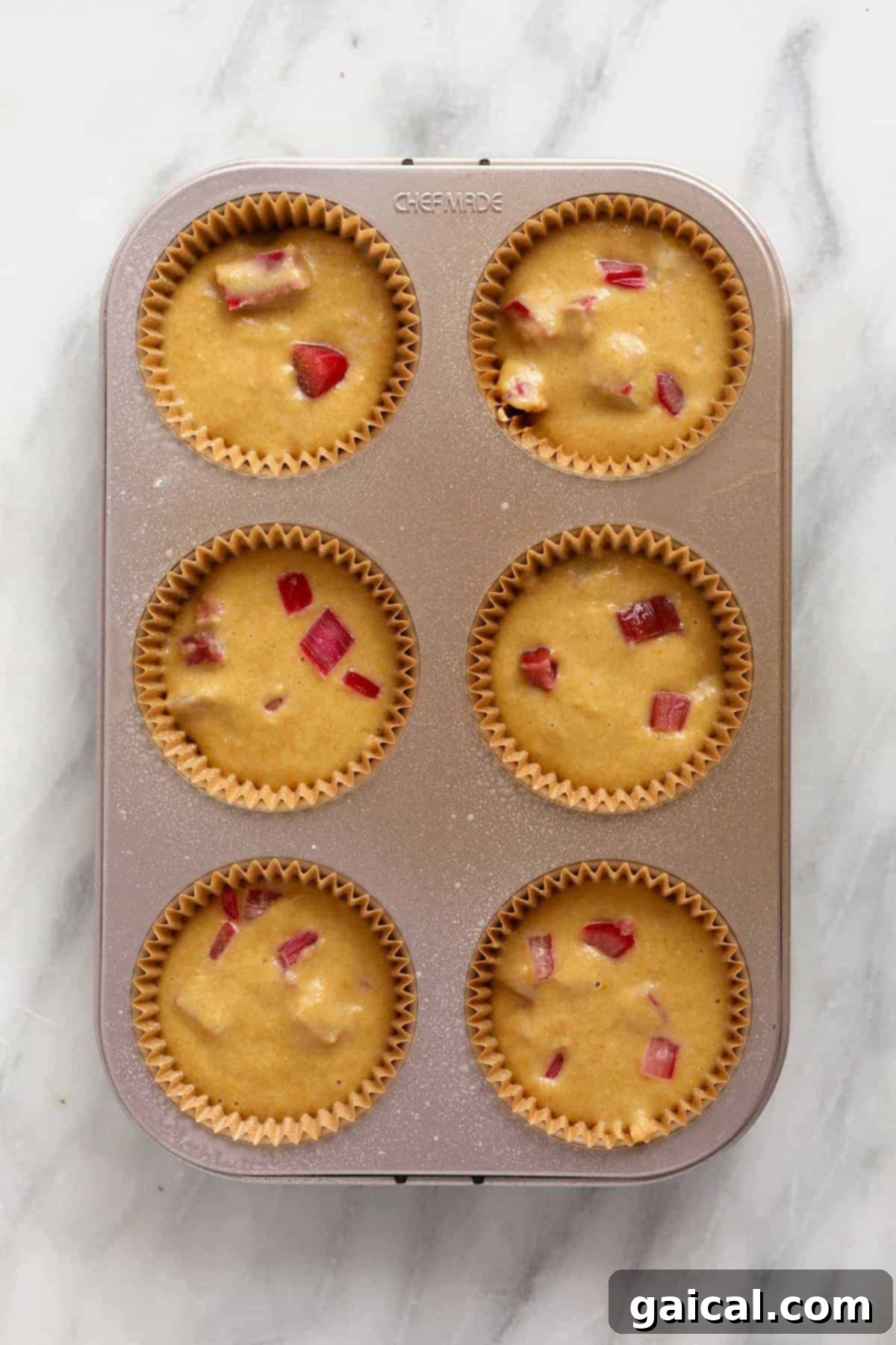 Sweet and Tangy Rhubarb Muffins 6 Rhubarb muffin batter in a muffin pan