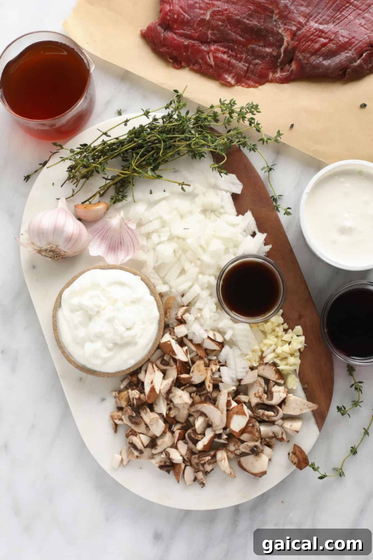 Simple Weeknight Beef Stroganoff 3 Essential ingredients for beef stroganoff: sour cream, Greek yogurt, beef strips, mushrooms, Worcestershire sauce, and fresh herbs.
