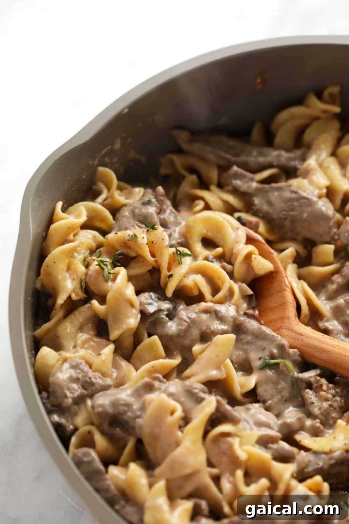 Simple Weeknight Beef Stroganoff 7 Classic beef stroganoff simmering in a pan, showcasing the rich, creamy sauce.