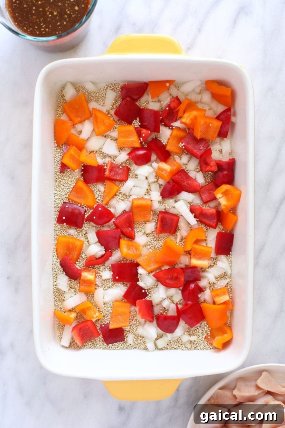 quinoa, peppers, and onion in casserole dish