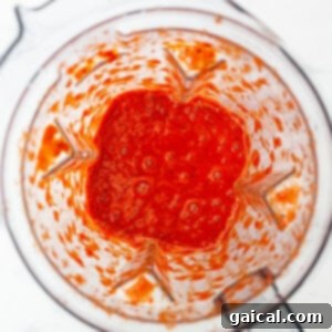 Hearty Quinoa Chili 4 Blended roasted red peppers in a high-speed blender, creating a smooth sauce.