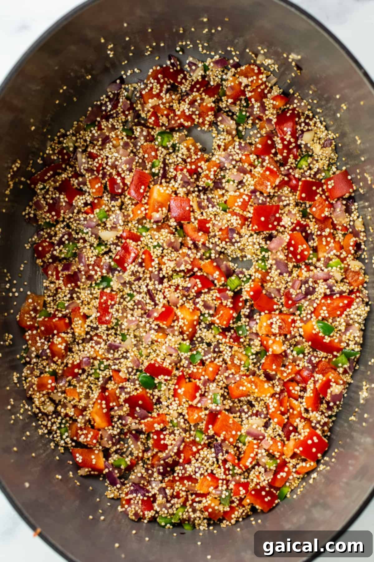 Cooking a delicious quinoa chili in a Dutch oven, a perfect one-pot meal. Rich and savory quinoa chili simmering to perfection in a classic Dutch oven, stirring in vegetables.