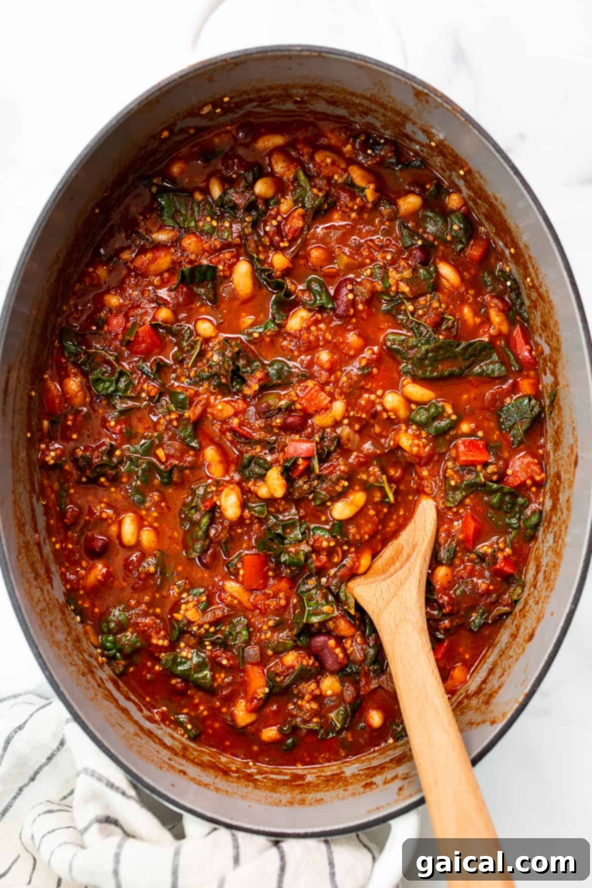 Hearty quinoa chili simmering in a Dutch oven, a perfect meal for cozy evenings. A large pot of rich quinoa chili, ready to be served, showcasing its vibrant colors and hearty ingredients.