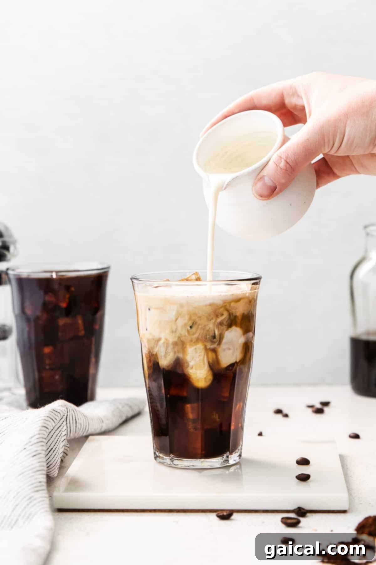 Crafting the Perfect Cold Brew 2 Pouring cream into cold brew coffee