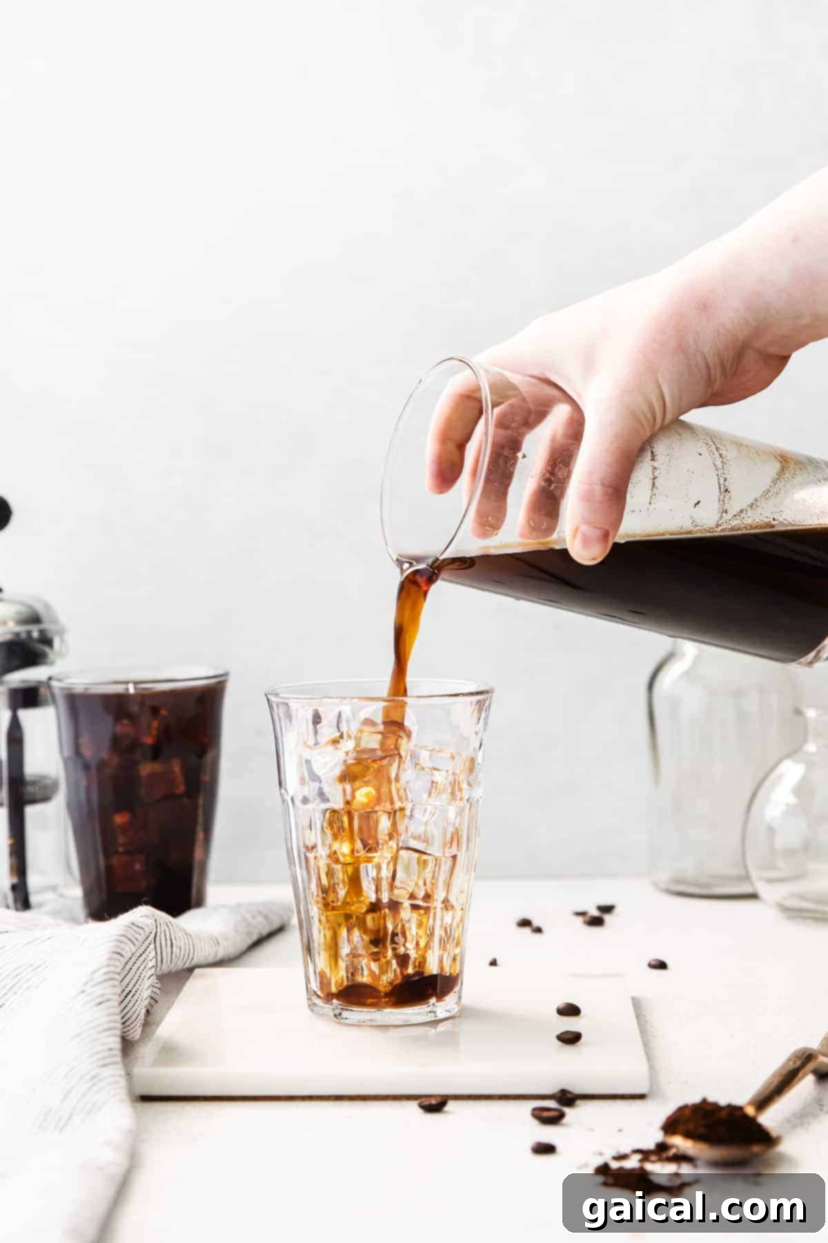 Crafting the Perfect Cold Brew 9 Pouring cold brew coffee into a glass