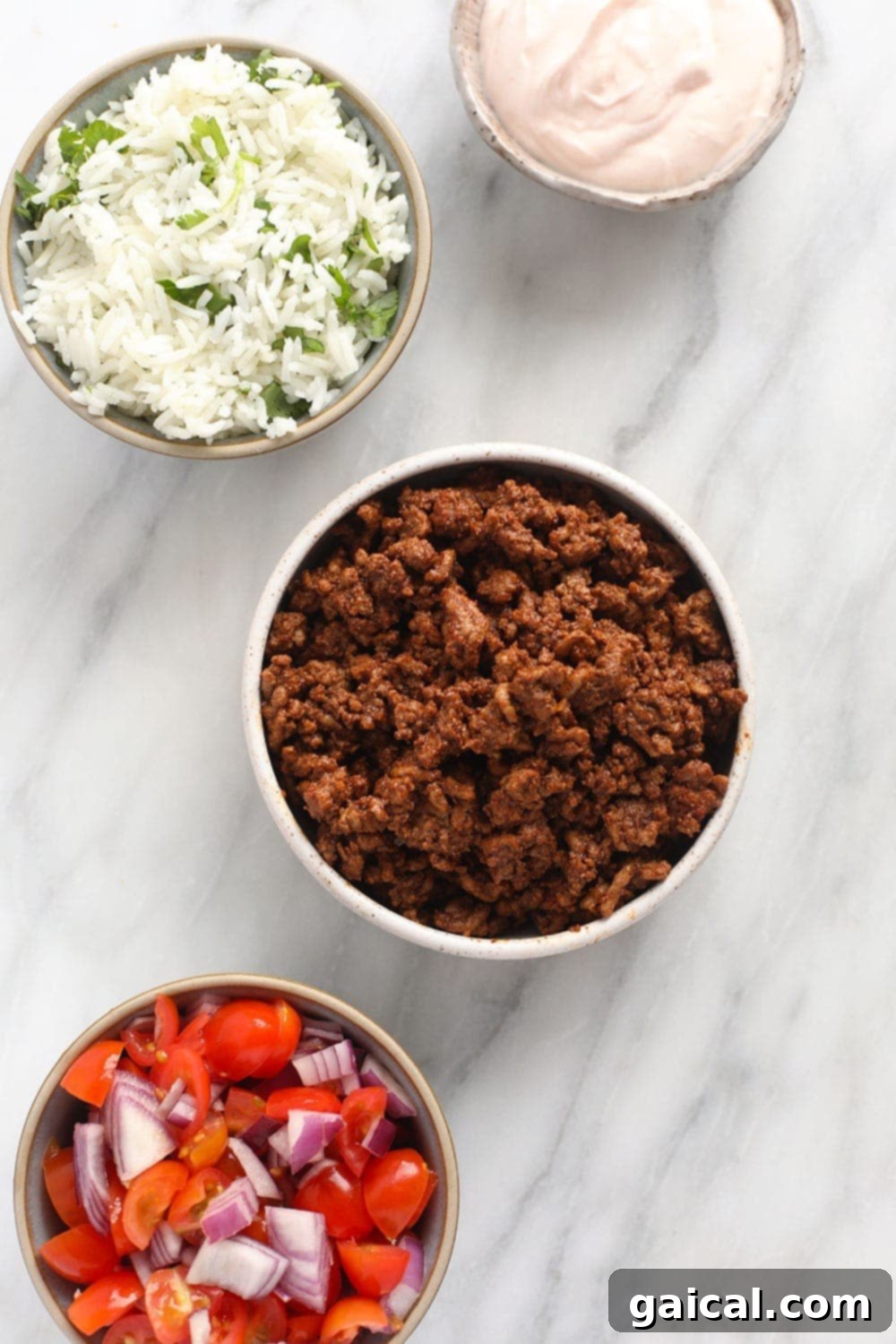 Whip up this filling beef taco bowl recipe for an incredible meal prep idea that's perfect for a work lunch or dinner at home! A vibrant selection of fresh ingredients for building perfect taco bowls.