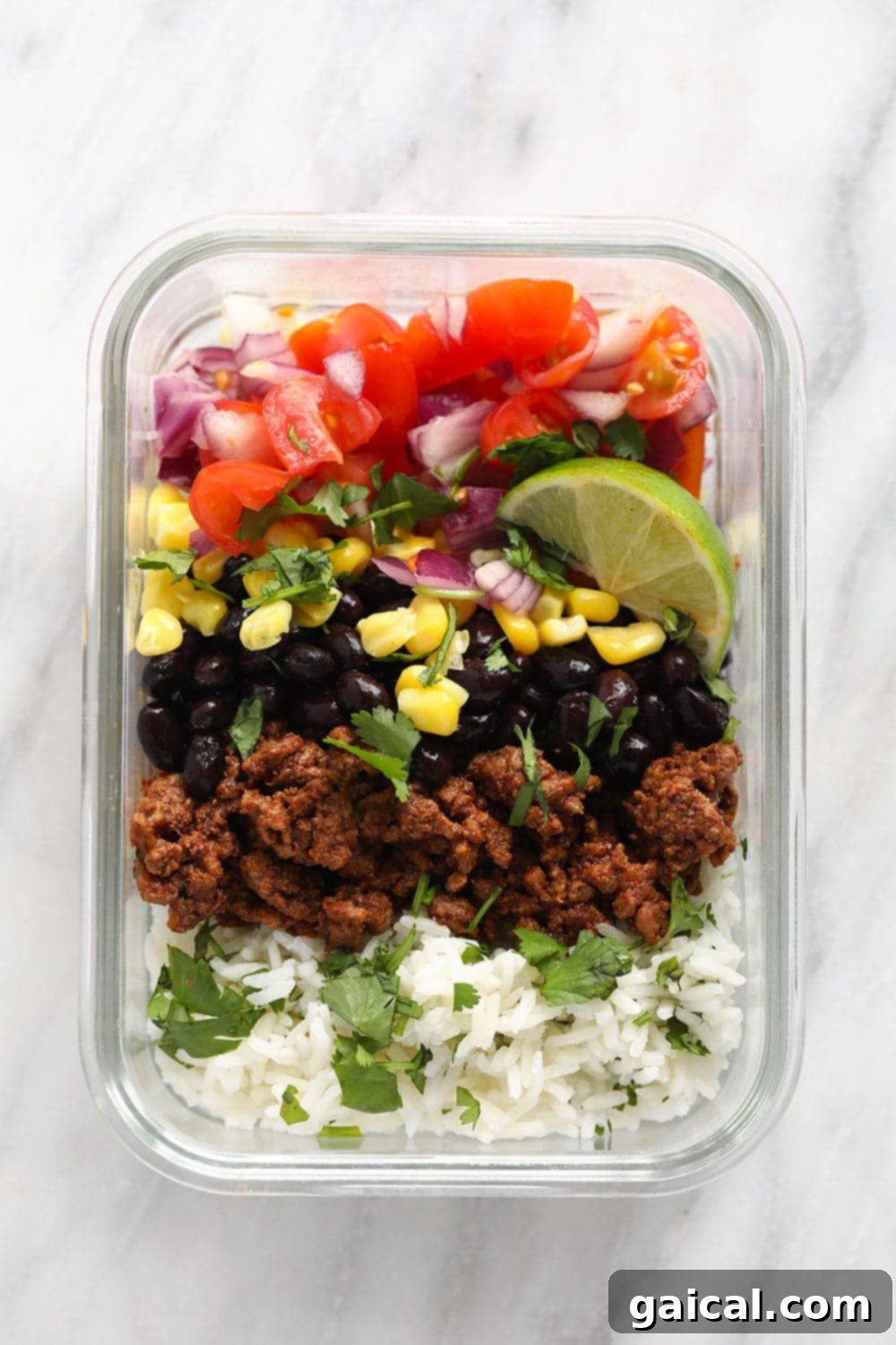 Whip up this filling beef taco bowl recipe for an incredible meal prep idea that's perfect for a work lunch or dinner at home! Hearty and healthy meal-prep taco bowls ready for a week of delicious lunches.