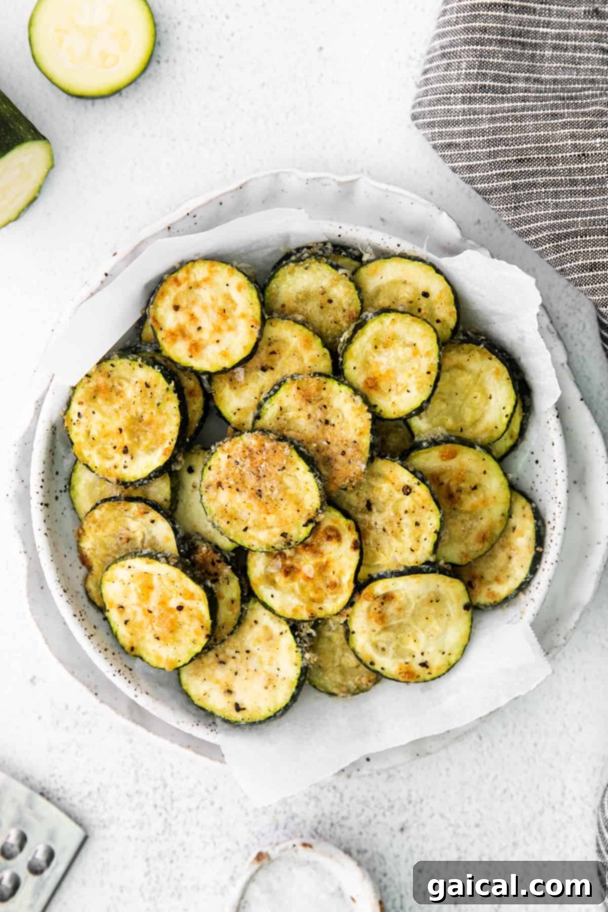 Crispy Parmesan Zucchini Bites 2 A vibrant bowl of golden, crispy Parmesan baked zucchini coins, perfectly baked and ready to be served.